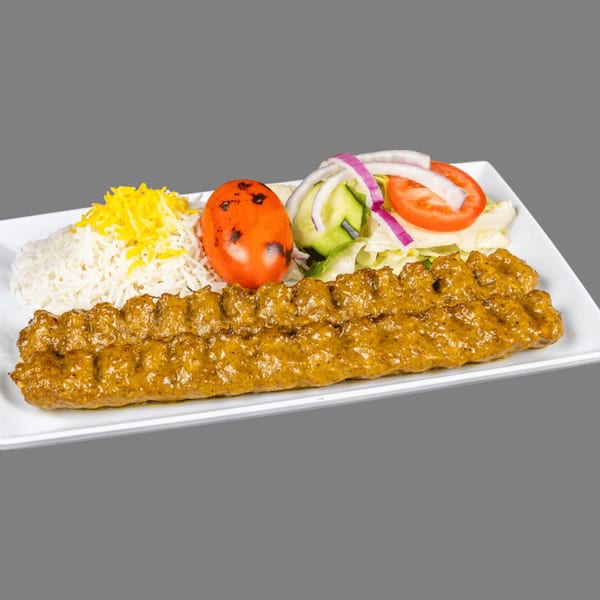 ZK Grill's Mediterranean koobideh kebab with rice, grilled tomato, and a side salad.